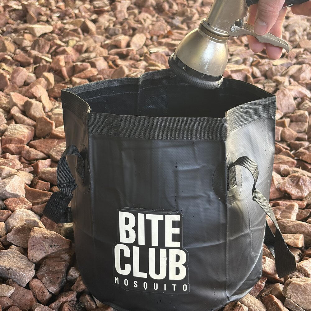 Topping off a Bite Club Mosquito container with a garden hose