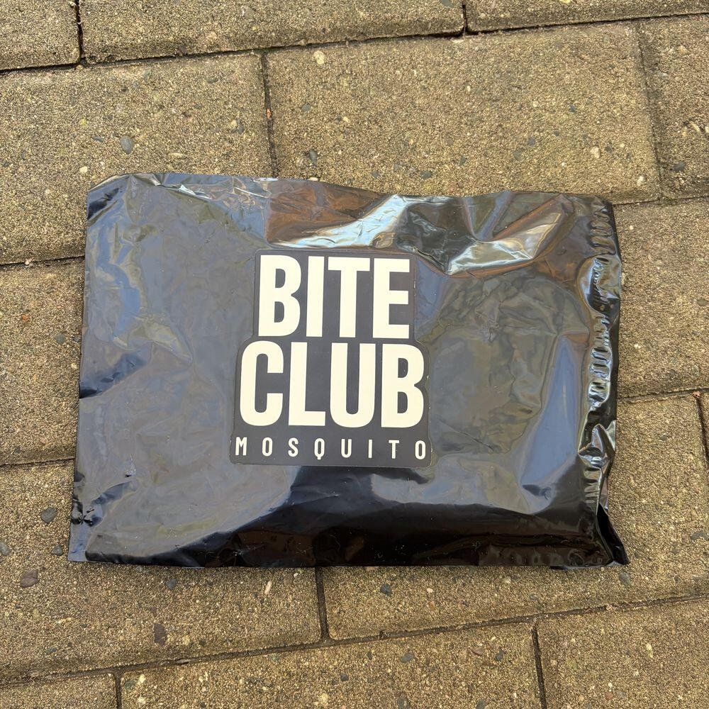 A Bite Club Mosquito refill mailer on a patio
